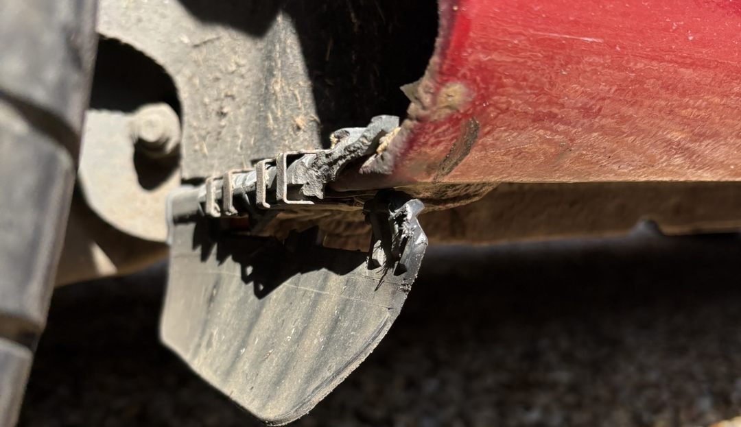 The original deflector cracked and hanging loose under the same arch